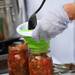 Residential Dinning Services employees Melissa Cummings fills canning jars with salsa during a demo during the MFarmers' Market set up outside of the Duderstadt Center on Thursday. Melanie Maxwell I AnnArbor.com
